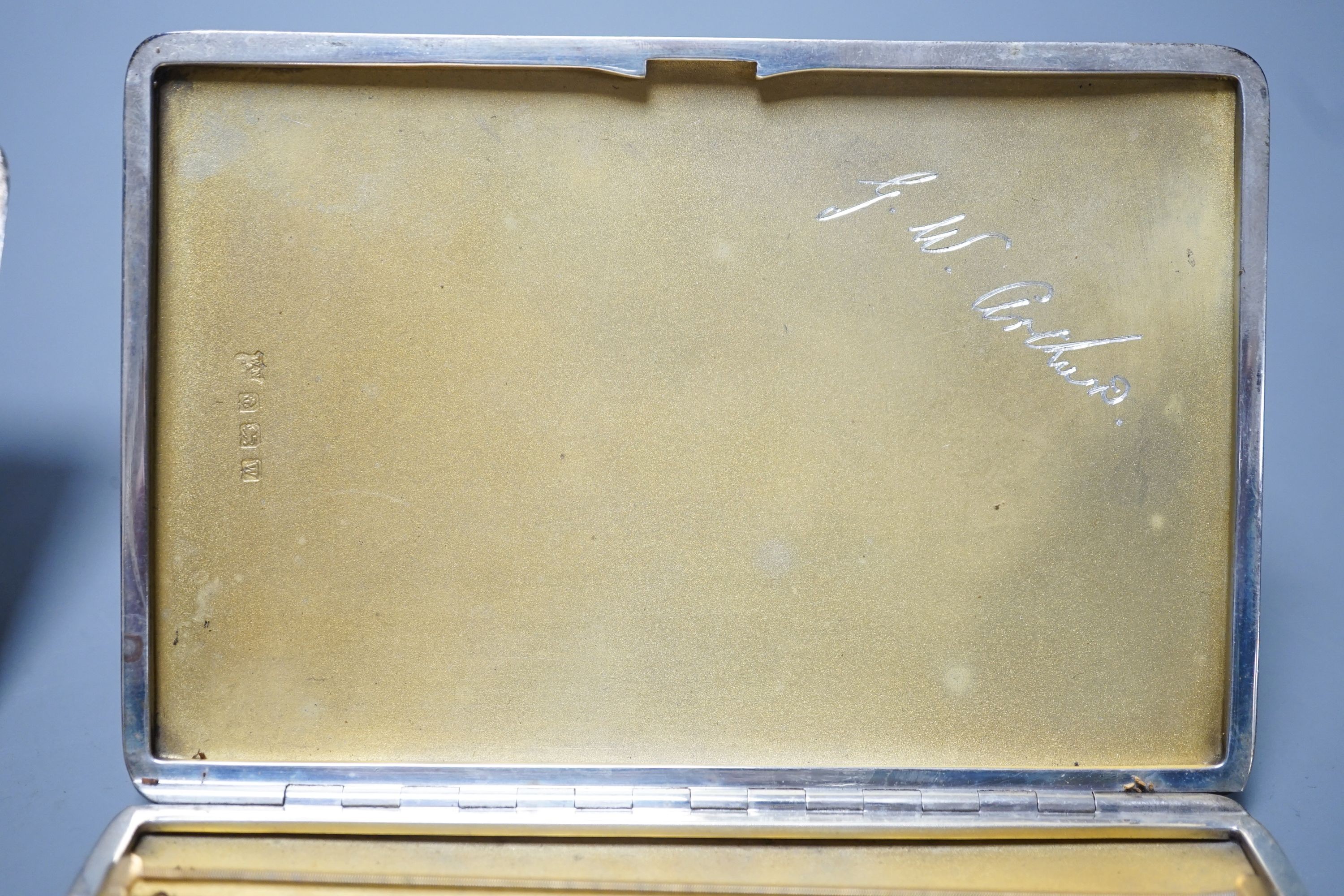 Three assorted silver cigarette cases and a silver card case, largest 14cm, gross 14oz.